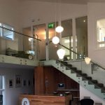Connaught whiskey glass and stainless steel stairs